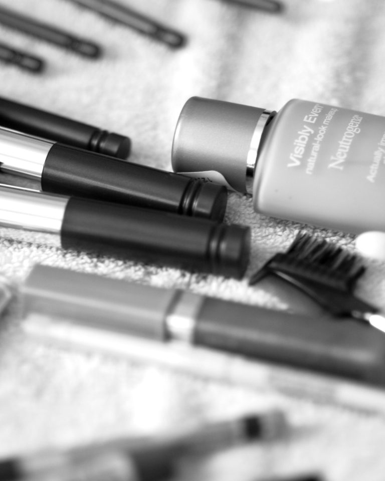 An assortment of makeup products and brushes on a table